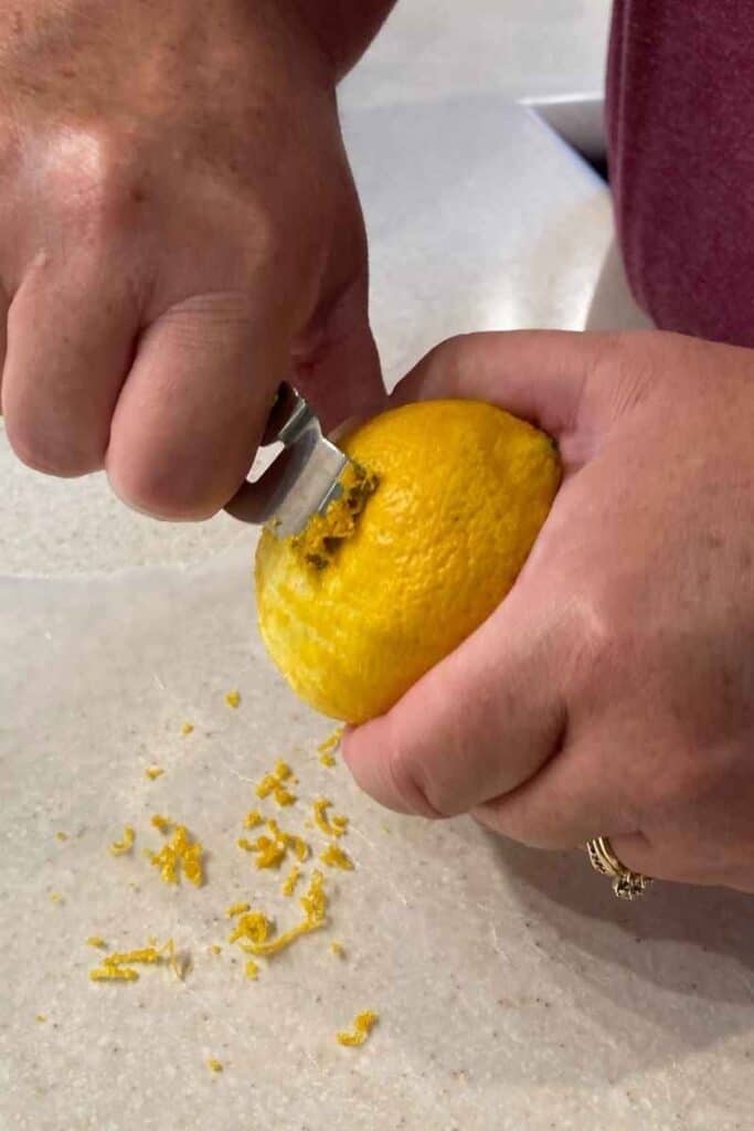 zest the lemon over the wax paper until there are 2 teaspoons of zest