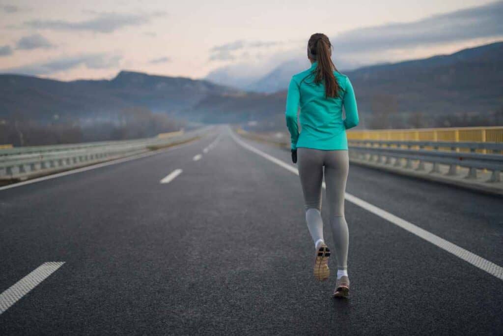 woman running long road with persistence
